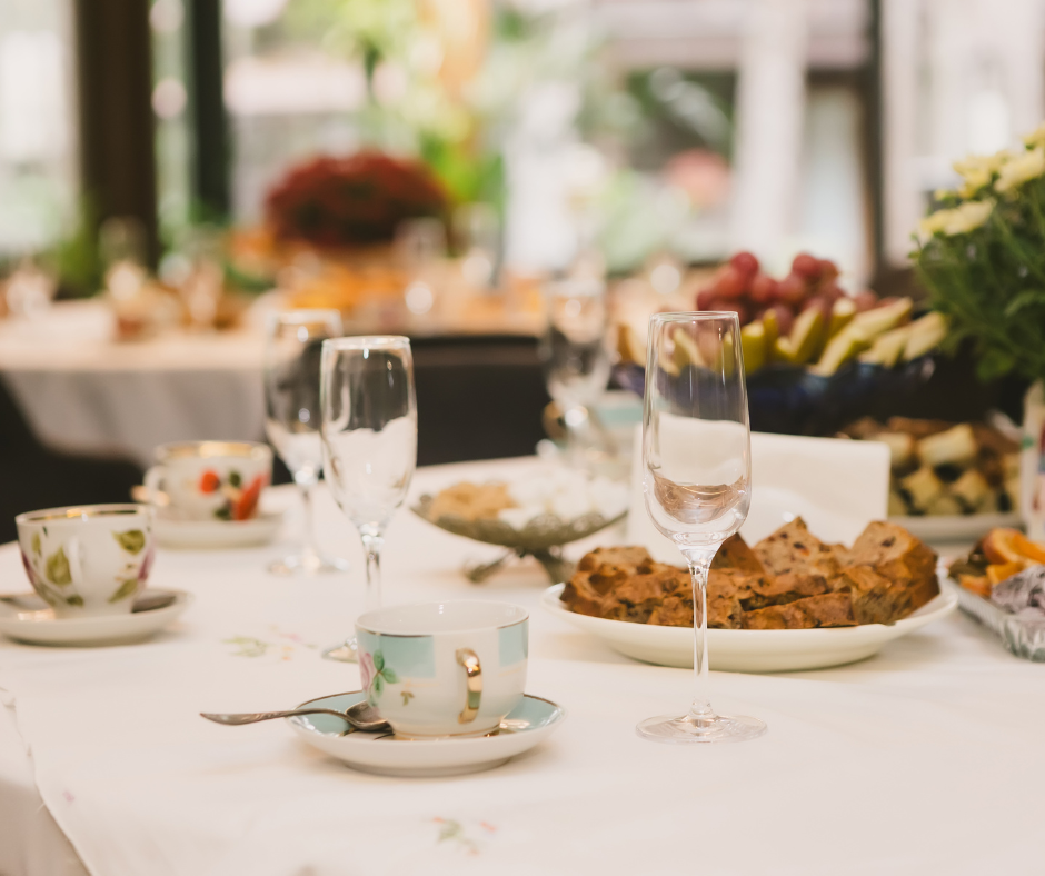 Table with glasses and tea cups at a High Tea event